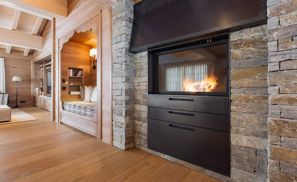 Ein Kaminofen eingefasst in Naturstein